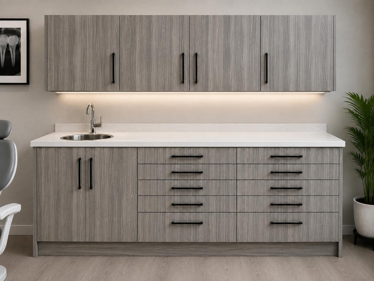 Light grey woodgrain dental side cabinet by DRM Dental with wall-mounted upper cabinets, under-cabinet lighting, quartz countertop, sink, and ten drawers