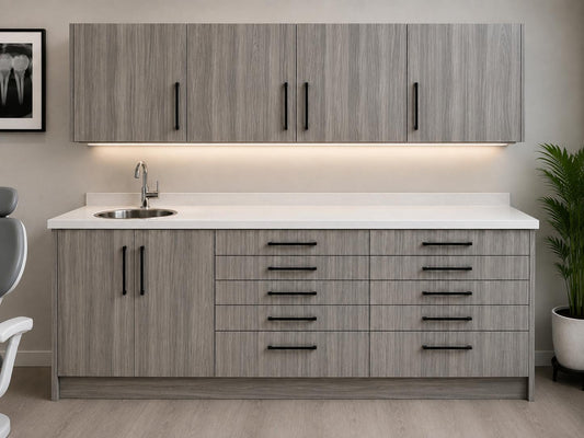 Light grey woodgrain dental side cabinet by DRM Dental with wall-mounted upper cabinets, under-cabinet lighting, quartz countertop, sink, and ten drawers